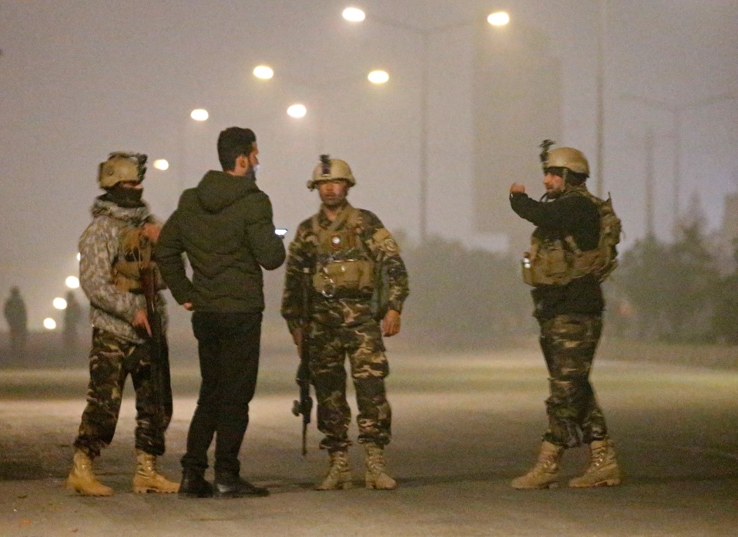 Afghan security forces keep watch near the site of an attack on the Intercontinental Hotel in...