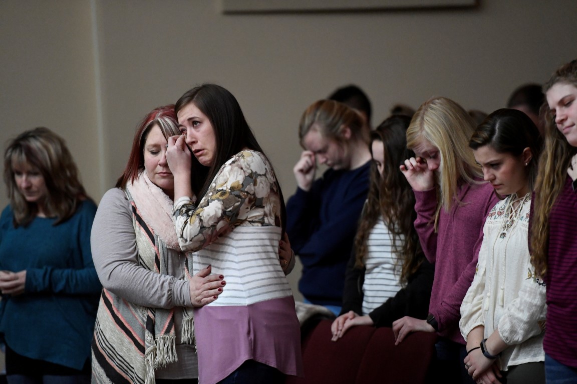 Marshall County High School students attend a prayer vigil for students killed and injured in the...