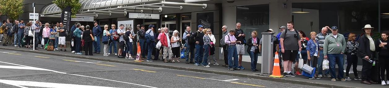 Cruise ship passengers wait in Moray Pl yesterday for a bus back to Port Chalmers. Photo: Shawn...