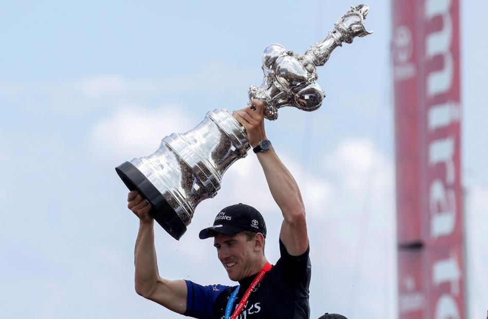 Team New Zealand's Peter Burling with the America's Cup trophy. 