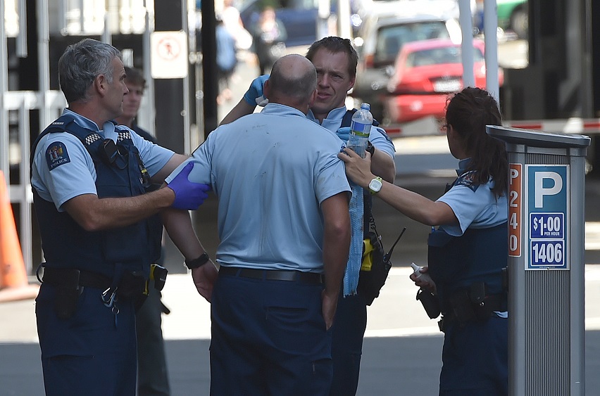 Police attend to an injured colleague after the incident in central Dunedin. Photo: Gregor...