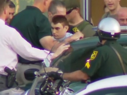 Shooting suspect Nikolaus Cruz is escorted out of hospital and into a police car: Image: WPLG