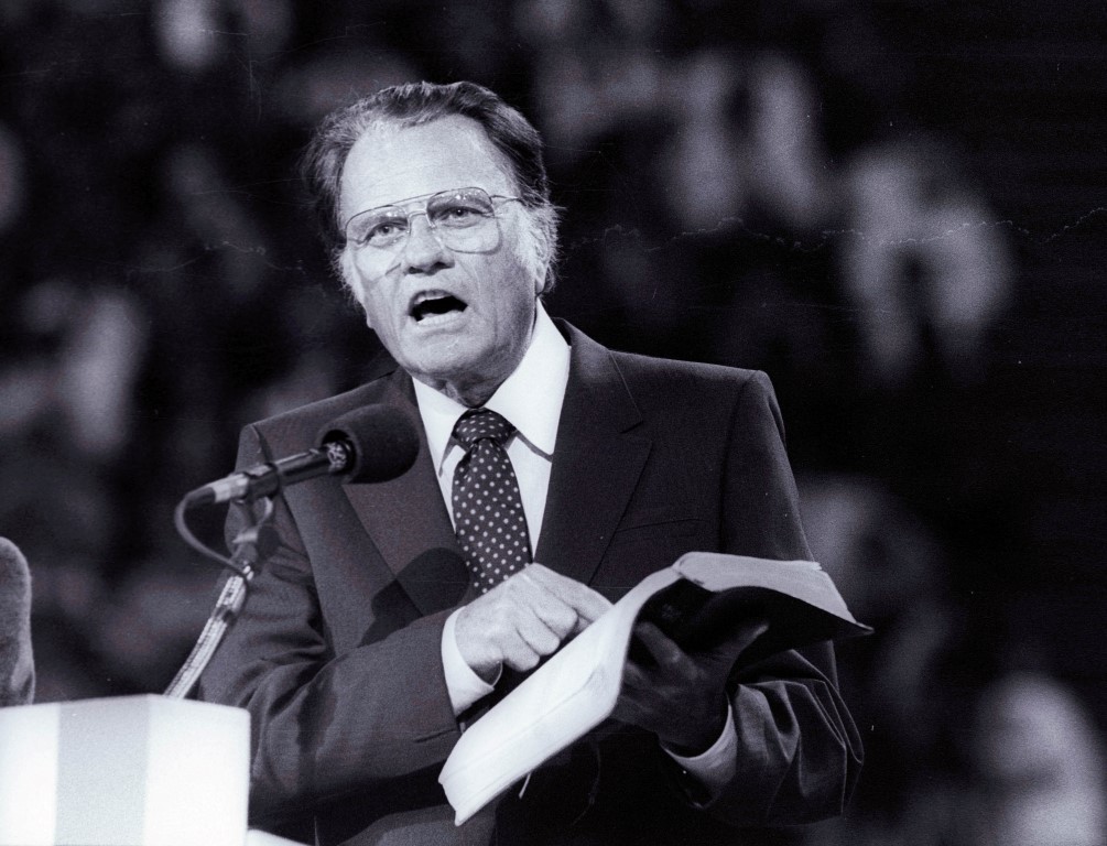 Billy Graham preaches the Gospel to thousands of believers during a meeting at Bercy's Stadium in...