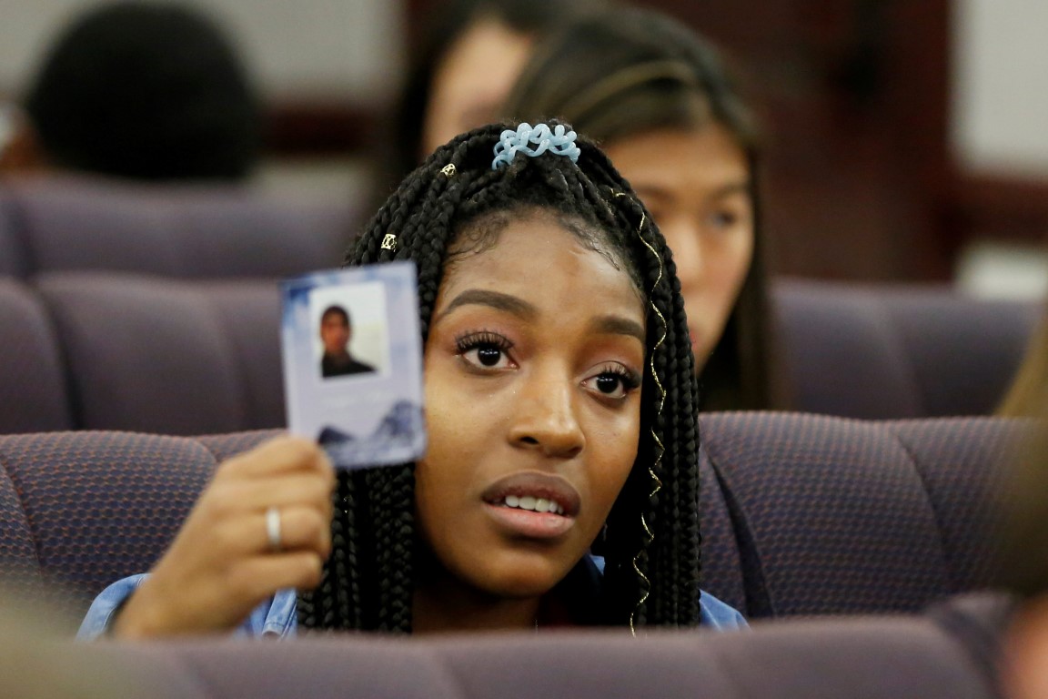 Marjory Stoneman Douglas High School pupil Tyra Hemans holds a photo of her friend Joaquin Oliver...