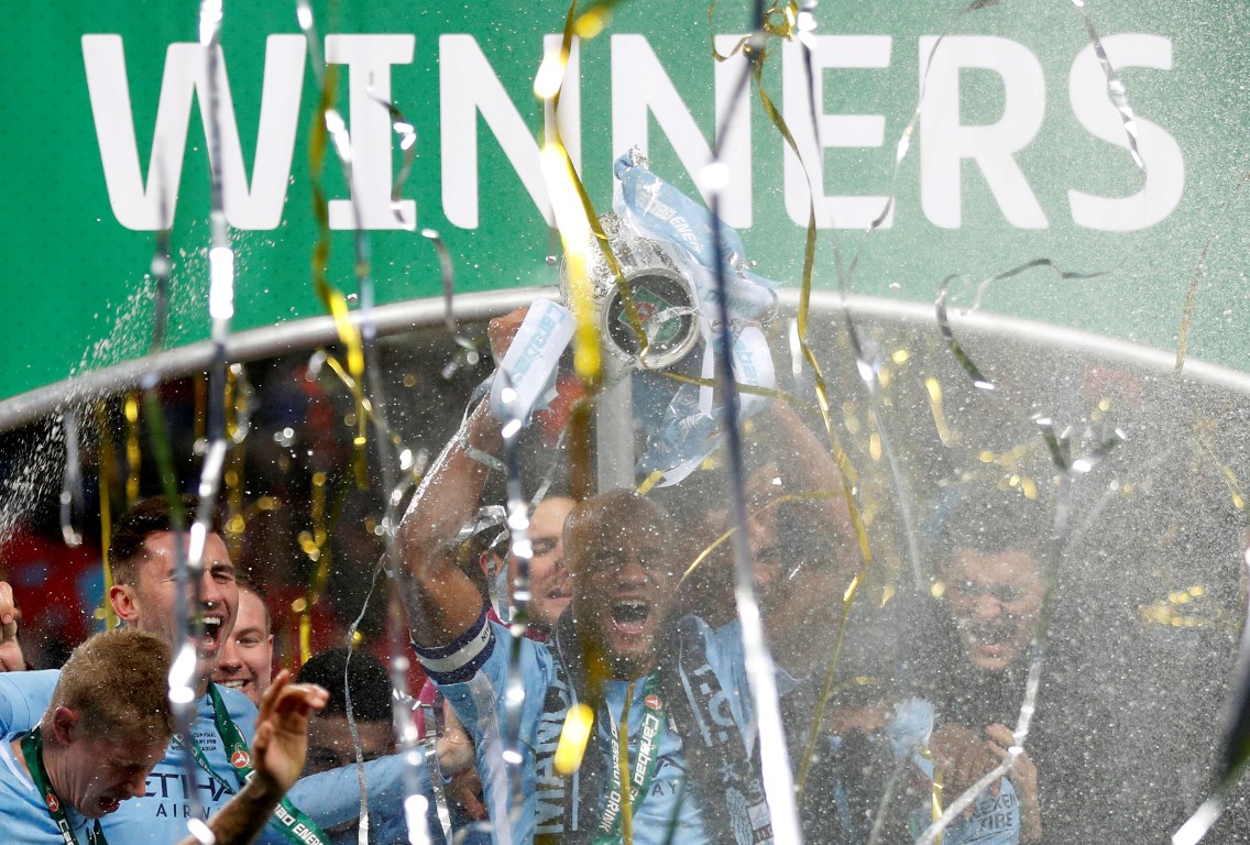 Manchester City’s Vincent Kompany lifts the trophy as they celebrate their League Cup victory....