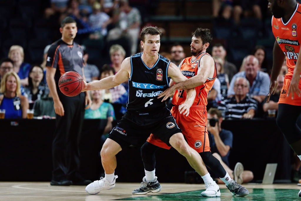 Retiring Breakers guard Kirk Penney posts-up Jarrad Weeks of the Cairns Taipans during an NBL...
