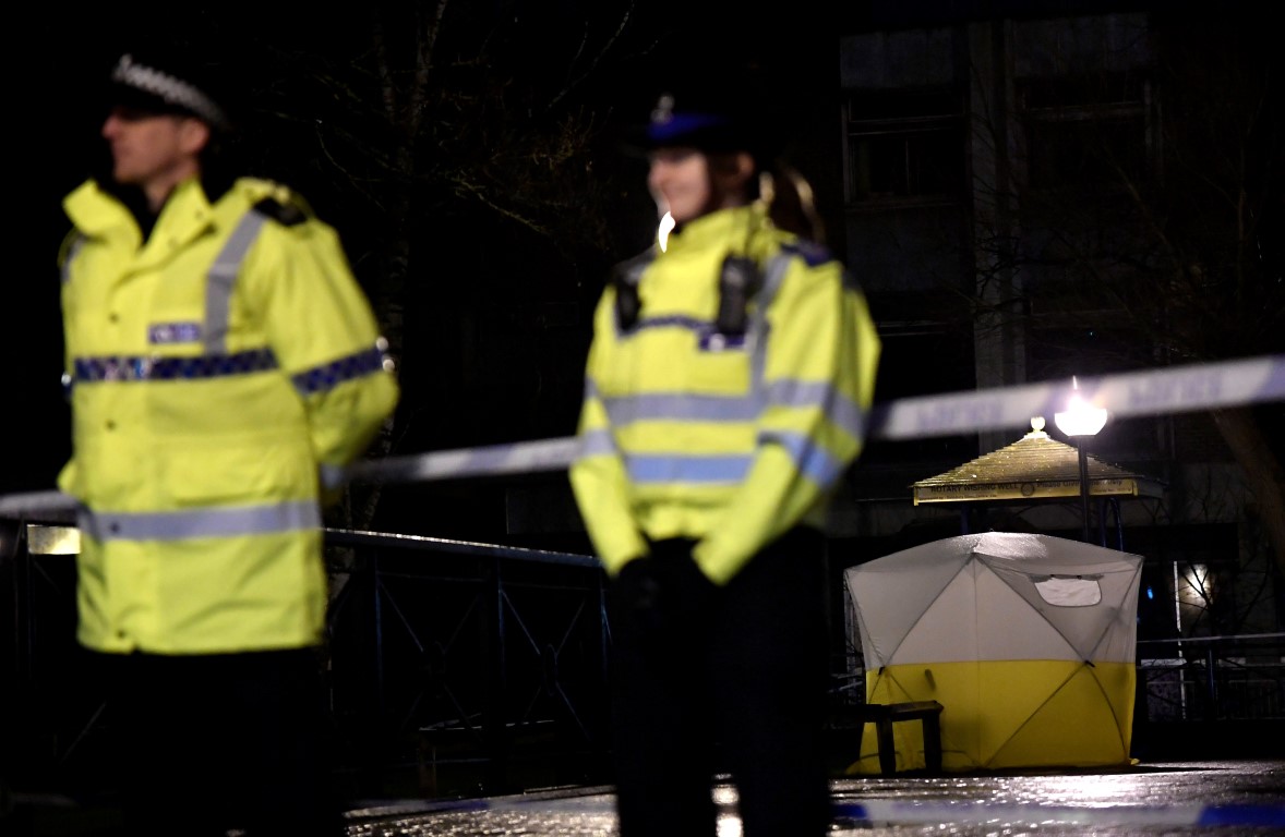 Police stand guard beside a cordoned-off area in Salisbury, southern England, after Sergei...