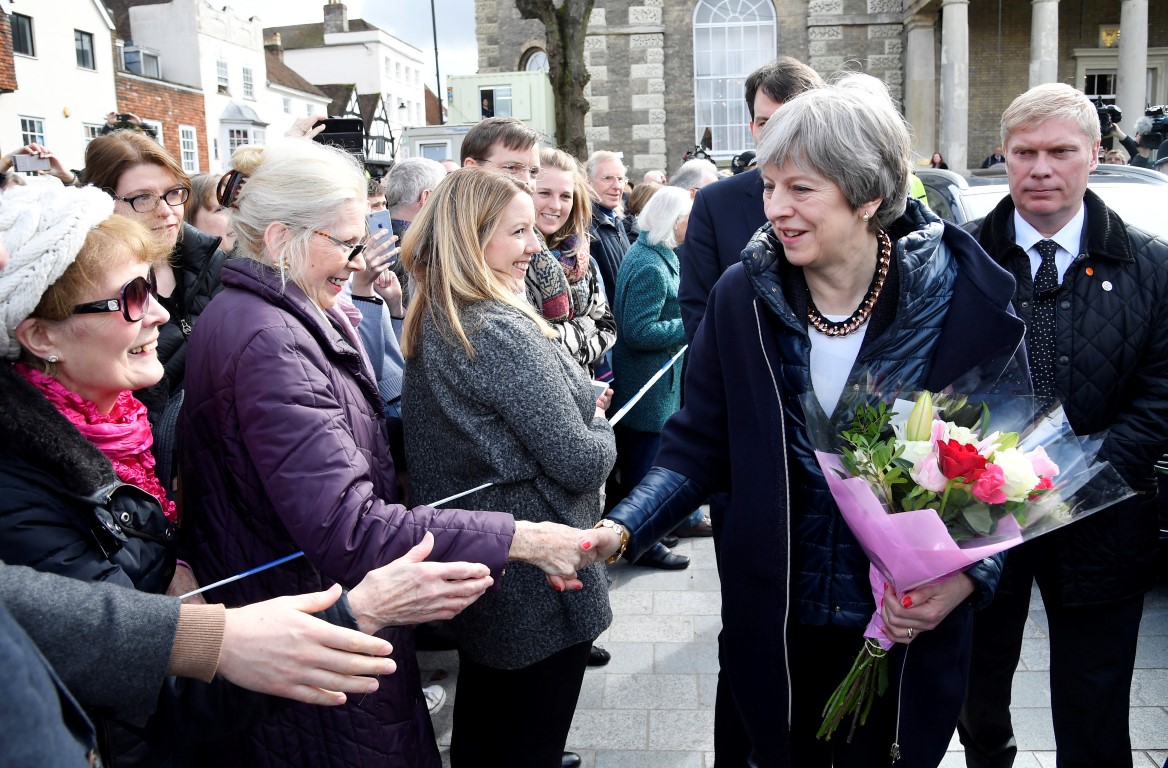 British Prime Minister Theresa May greets people after visiting the scene in Salisbury where...