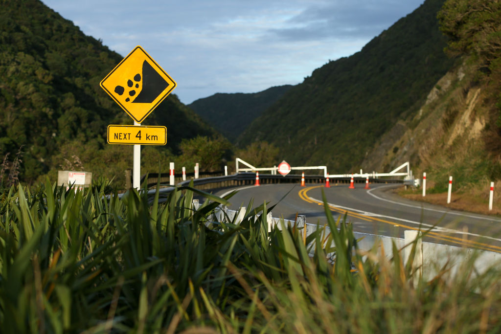 A sign warns of slip danger in front of a road closure barrier at the Manawatu Gorge. Photo:...