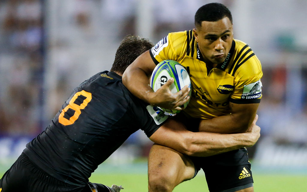 The Hurricanes' Ngani Laumape is caught by the Jaguares' Tomas Lezana. Photo: Getty 