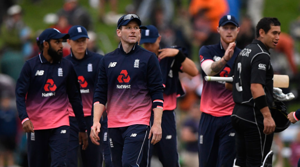 England captain Eoin Morgan leaves the field as his teammate Ben Stokes congratulates Ross Taylor...