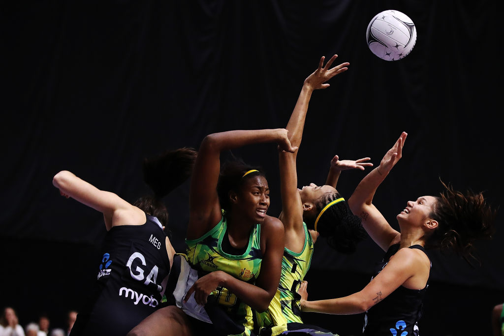 Bailey Mes and Ameliaranne Ekenasio of the Silver Ferns compete for the ball with Stacian Facey...