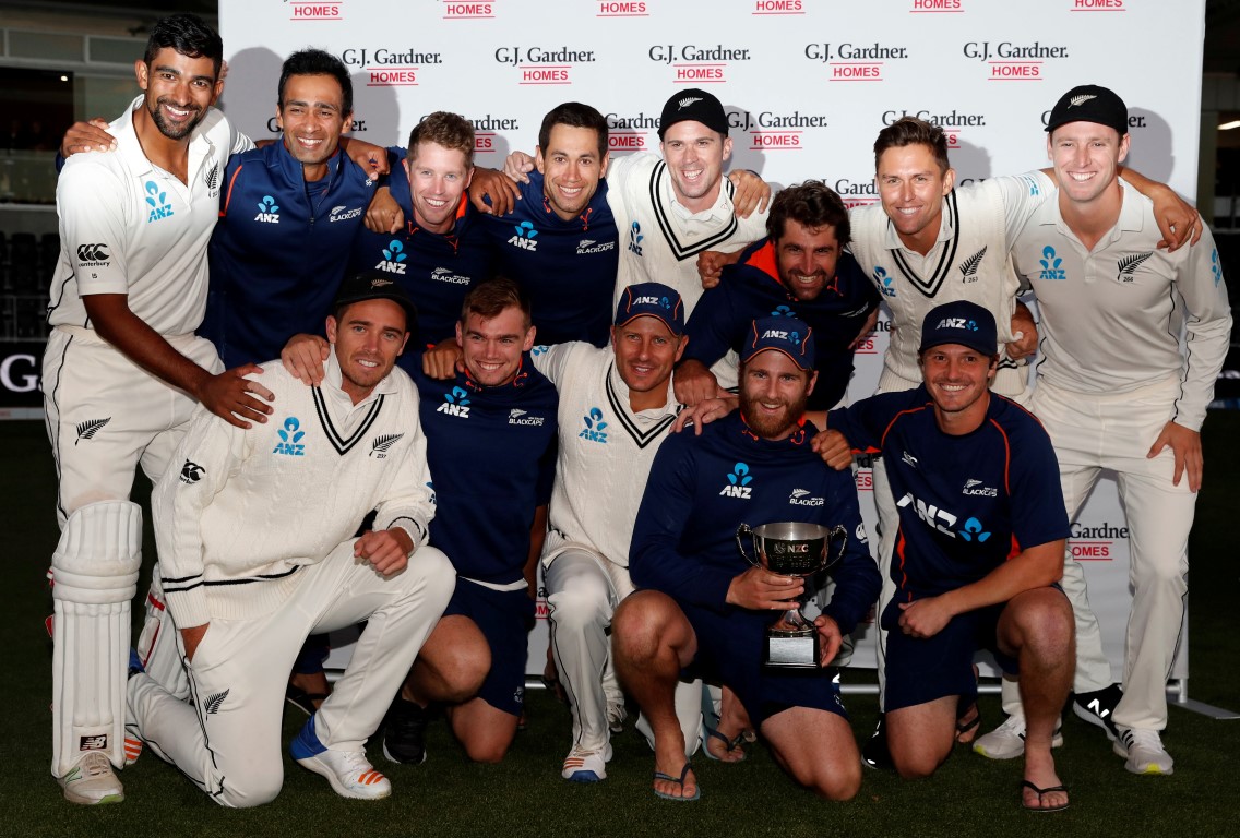 The Black Caps celebrate with the trophy after drawing the second test to secure a series victory...