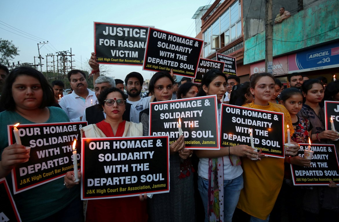 People hold a protest in Jammu to demand an investigation into the rape and murder of an 8-year...