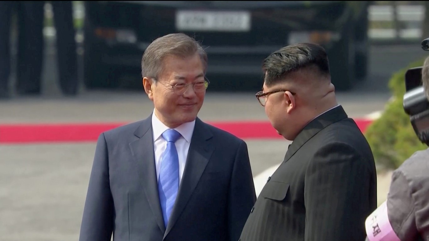 South Korean President Moon Jae-in (L) and North Korean leader Kim Jong Un at a welcome ceremony...