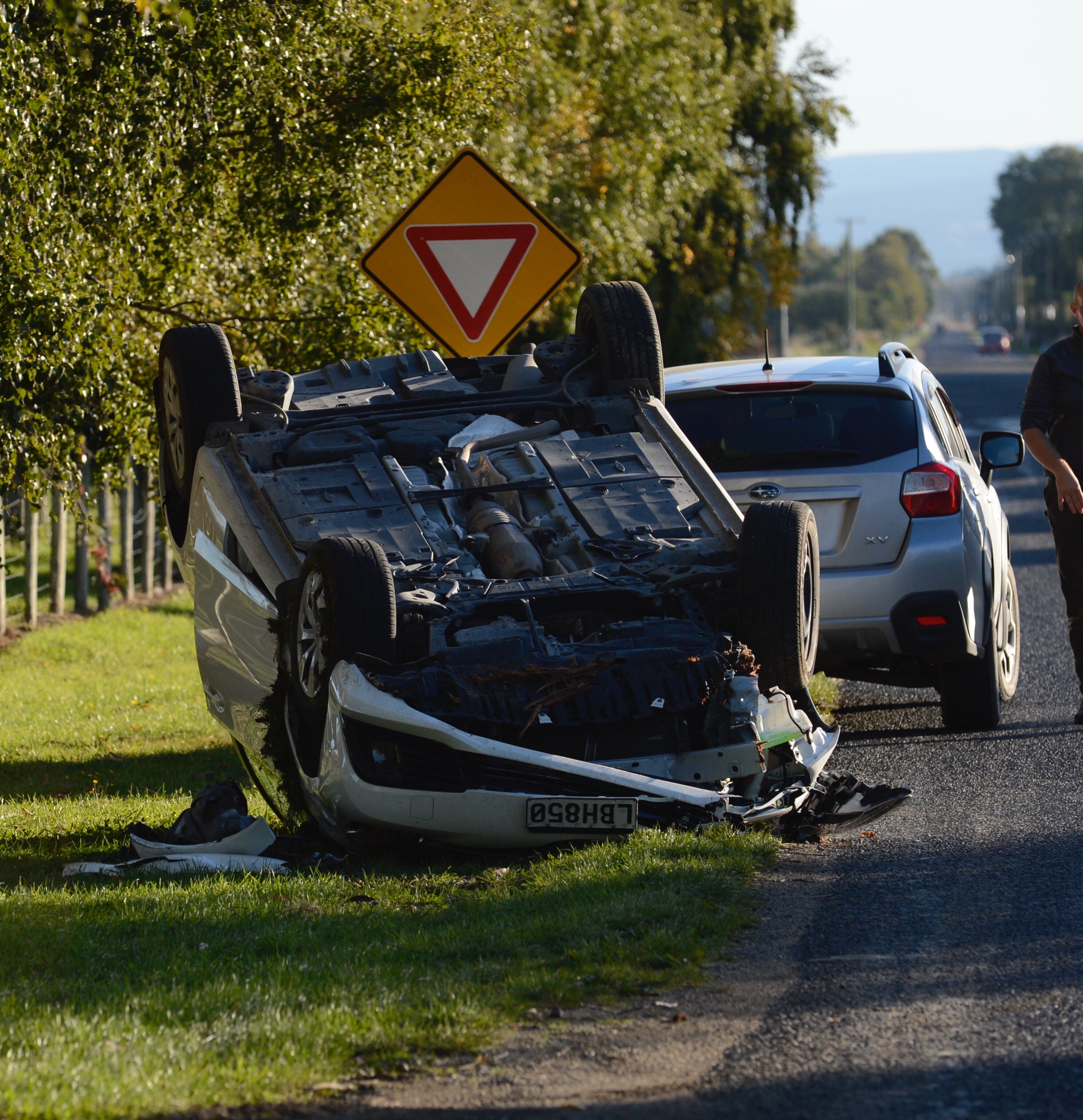 Two people sustained injuries after their car flipped on Dukes Rd today. Photo: Gerard O'Brien