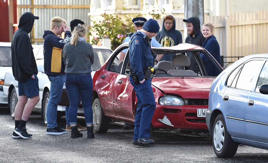 Police inspect the damaged vehicle on Hyde St. Photo: Peter McIntosh