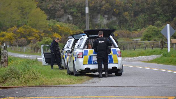 Police dog handlers at the scene where George Warren was arrested, just north of Arahura township...