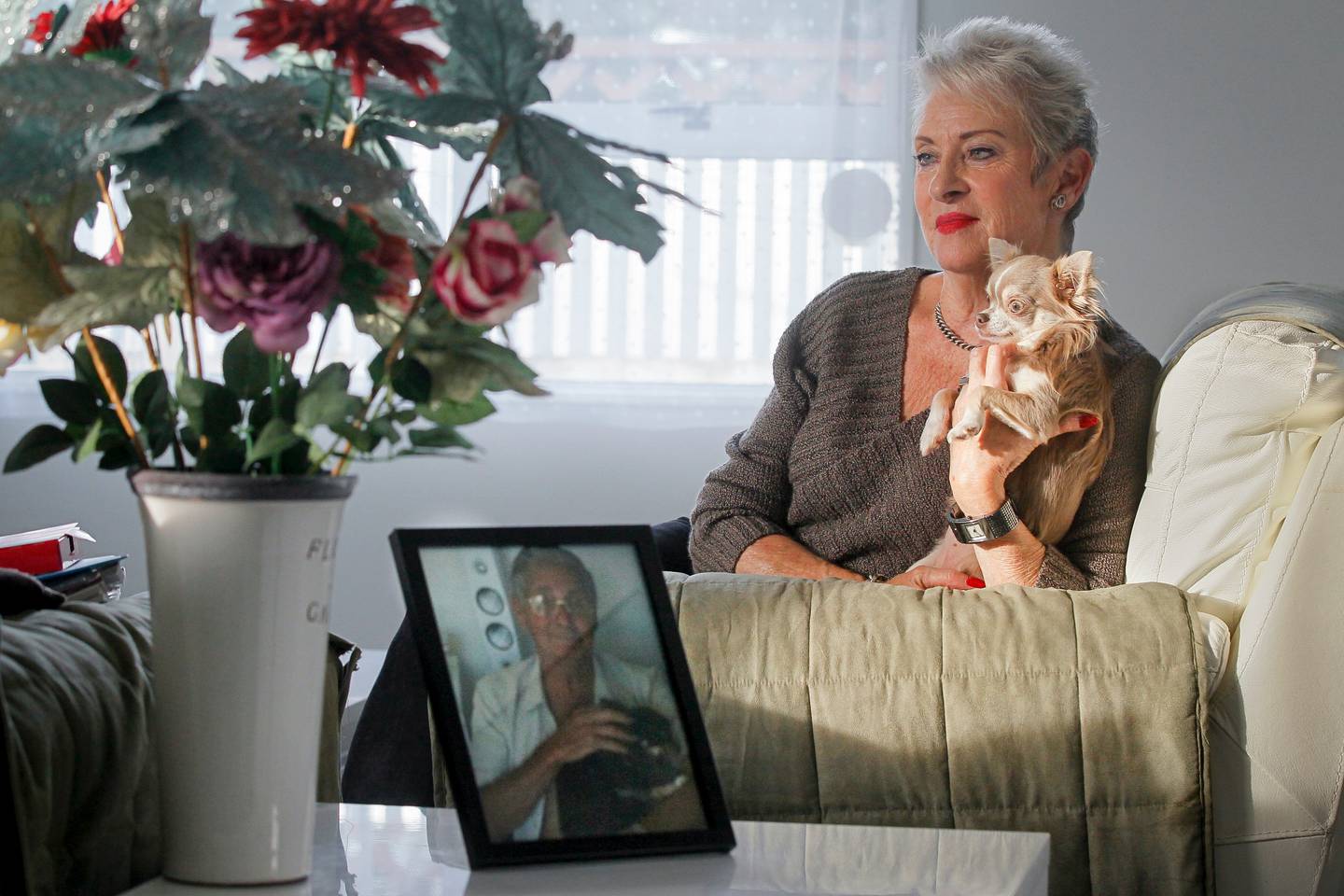 Toni Woods in her home in Hastings with a photograph of her late husband, Lindsay Collinson....