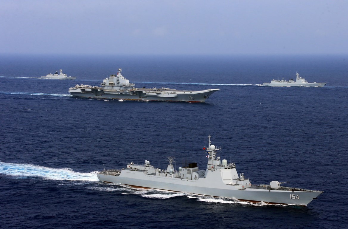 Chinese aircraft carrier Liaoning (C) takes part in a military drill in the western Pacific Ocean...
