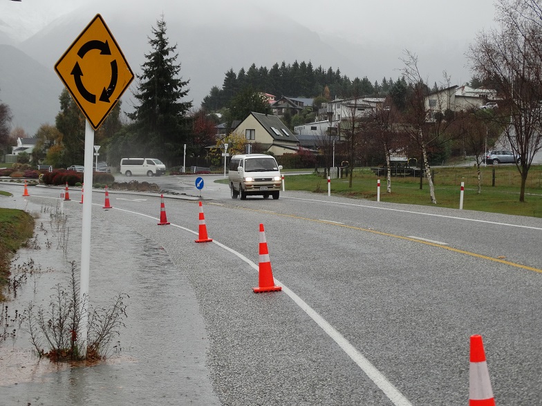 Cones warned motorists of surface flooding near the entrance to the Anderson Rd roundabout in...