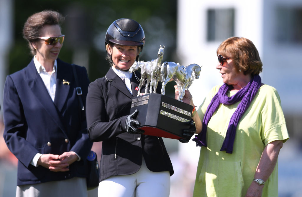 Jonelle Price poses with the trophy flanked by by HRH Princess Anne (L) and Classic Moet's co...