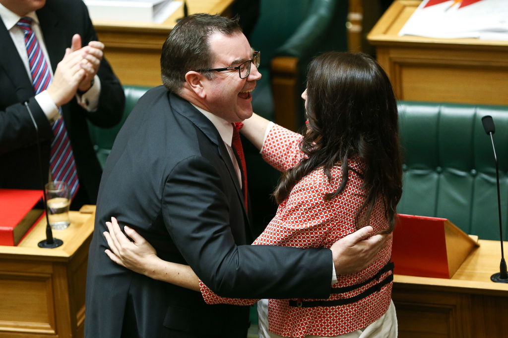 Finance Minister Grant Robertson is embraced by Prime Minister Jacinda Ardern after his 2018...