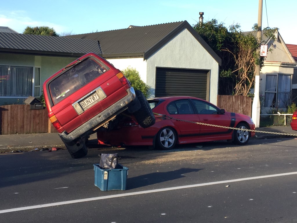 The 4WD ended up on the back of a Ford Falcon parked on the street after the crash. Photo: Gregor...
