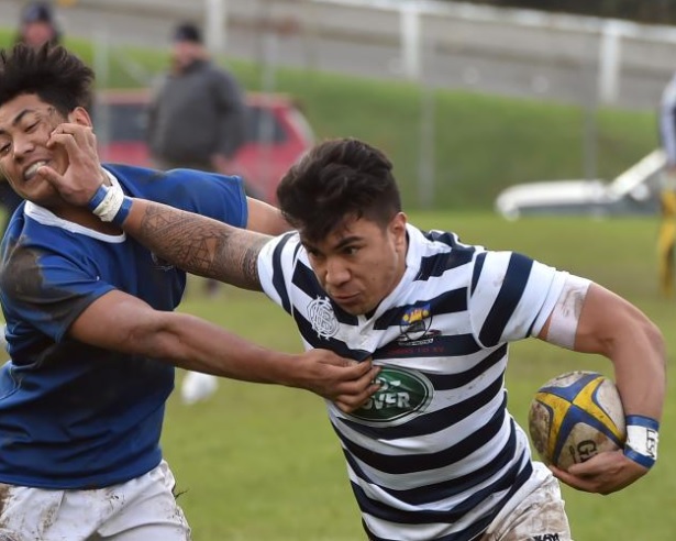 Otago Boys' High School flanker Josiah Lesa fends off Southland Boys' High School centre Junior...