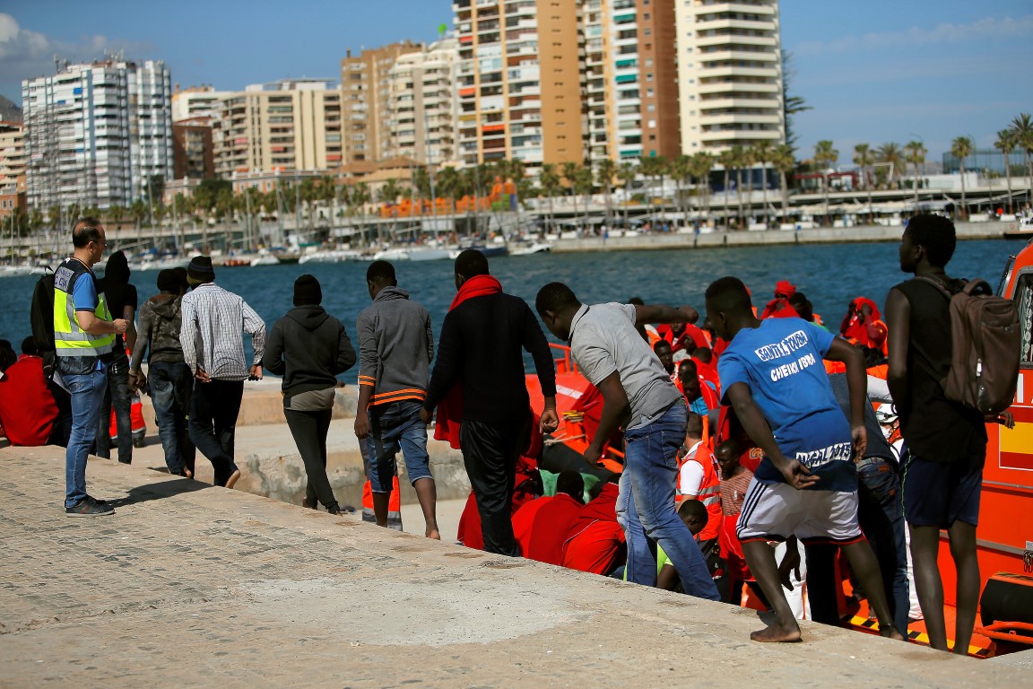 Migrants, part of a group intercepted aboard two dinghies off the coast in the Mediterranean Sea,...