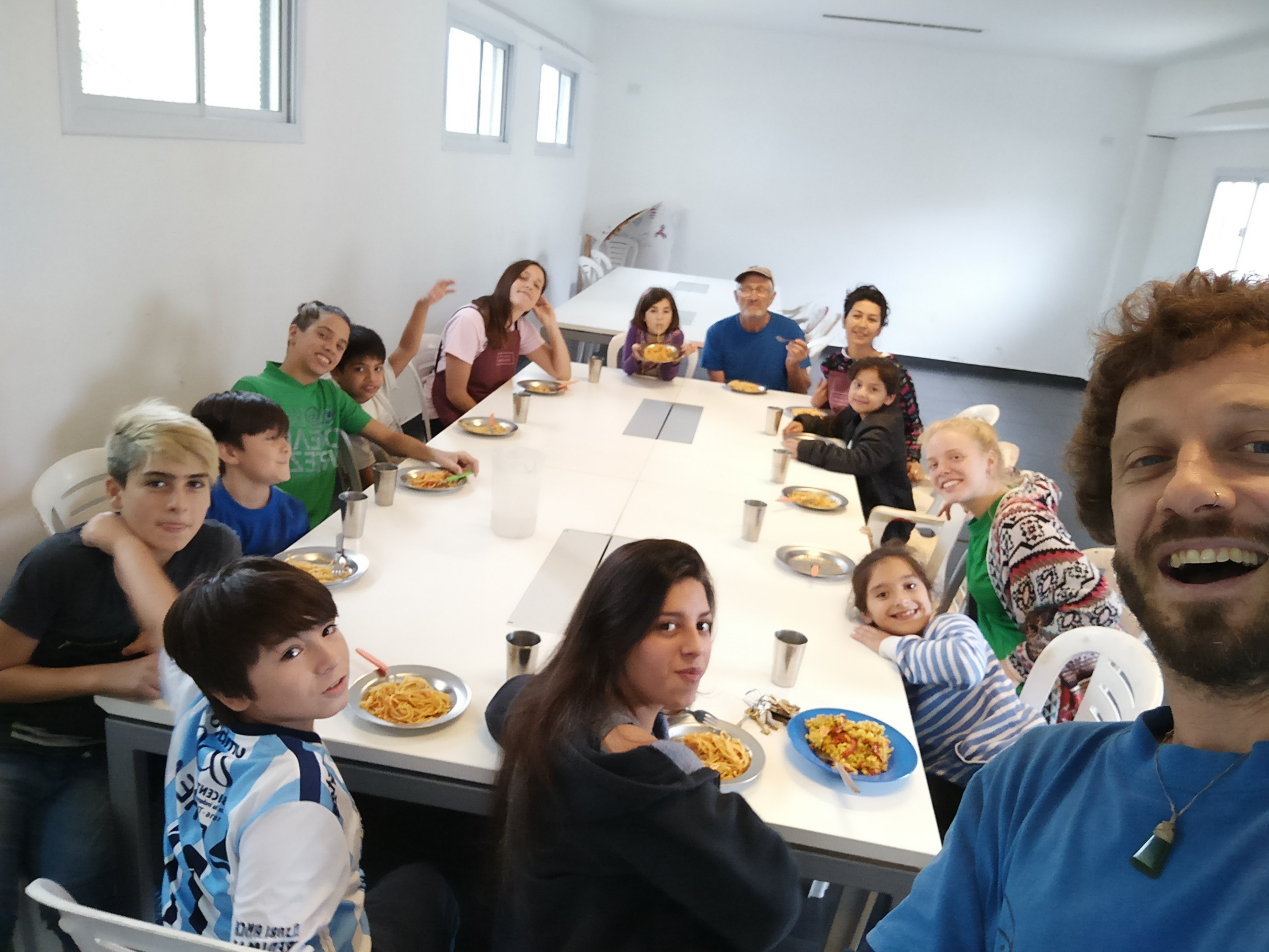 Former Alexandra man Ben Whitaker (front right) hangs out with some of those at his Food for...