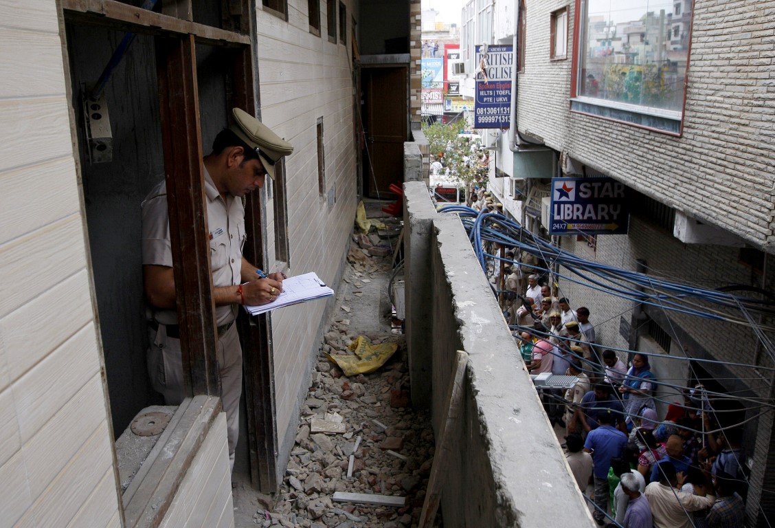 A police officer takes notes at the scene in New Delhi. Photo: Reuters