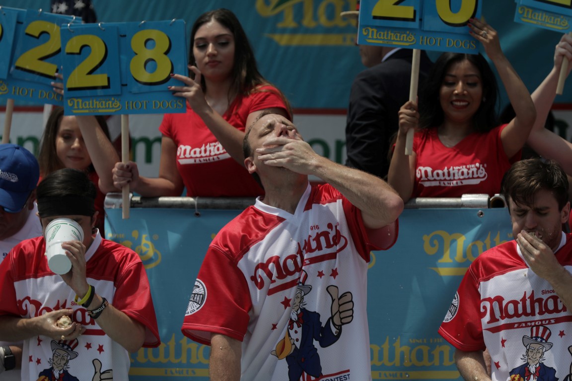 Joey Chestnut wins the annual Nathan's Hot Dog Eating Contest, setting a world record by eating...
