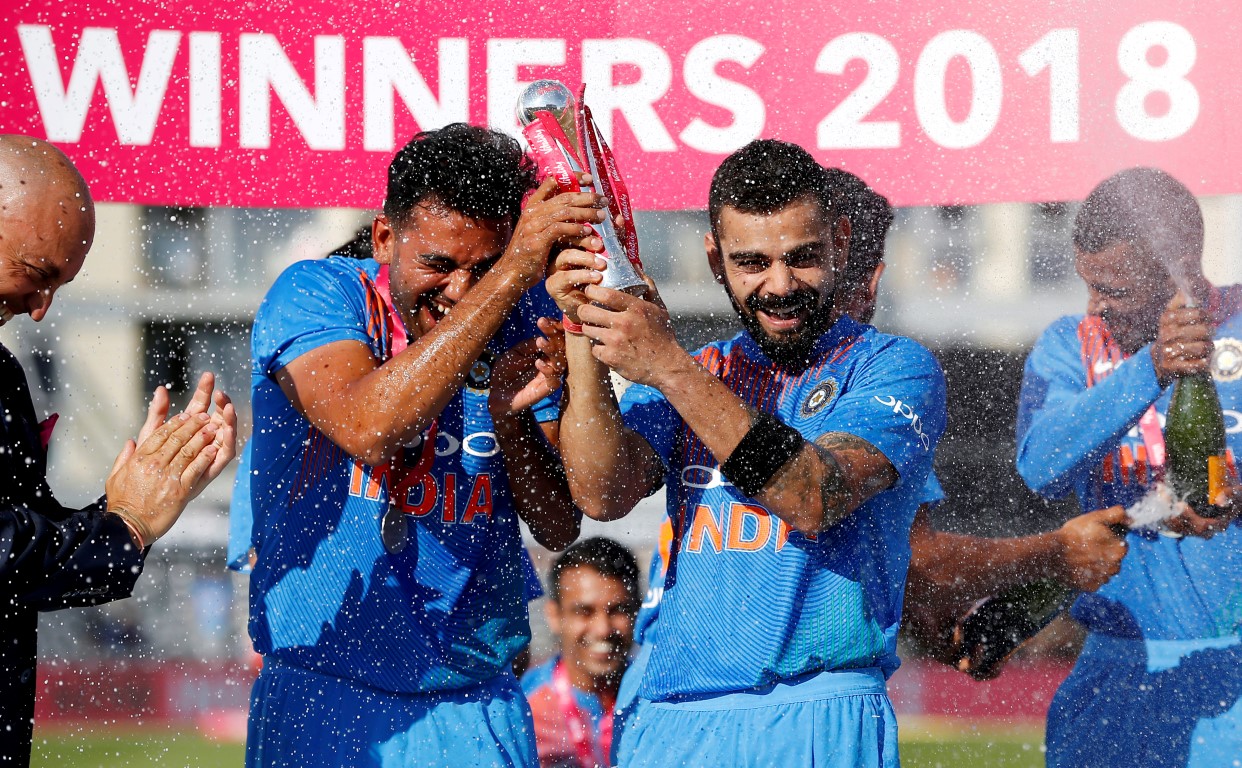 India players celebrate with the trophy after beating England in the third T20 match at The...