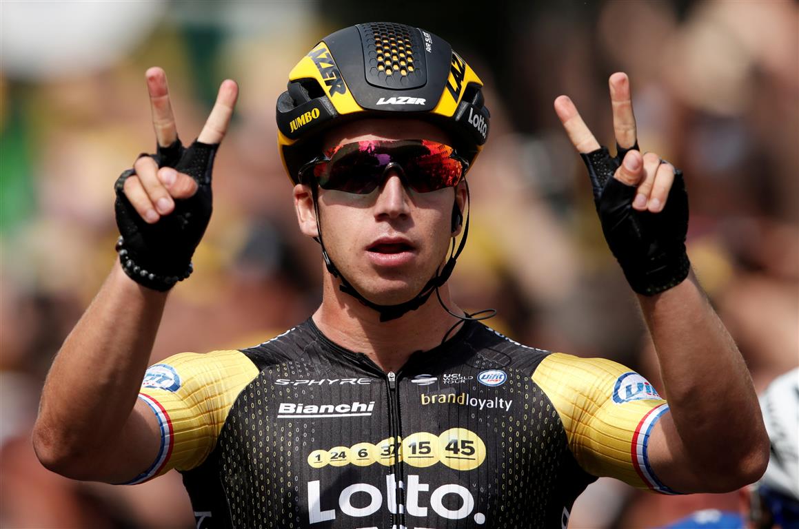 Dylan Groenewegen celebrates after crossing the line to win the eighth stage of the Tour de...