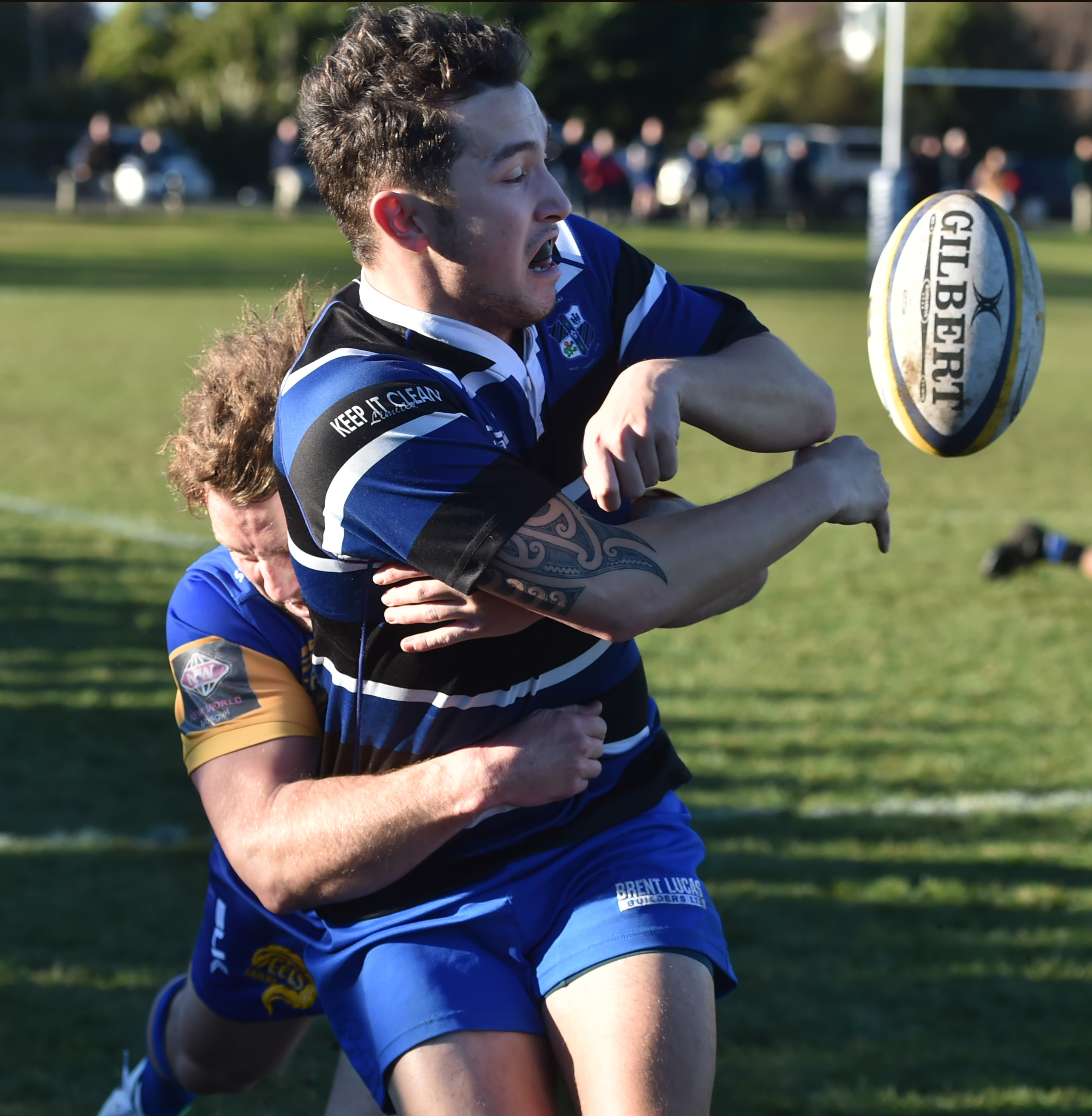 Kaikorai winger Jordan McEntee is tackled by Taieri outside back Mitchell Scott at Bishopscourt...