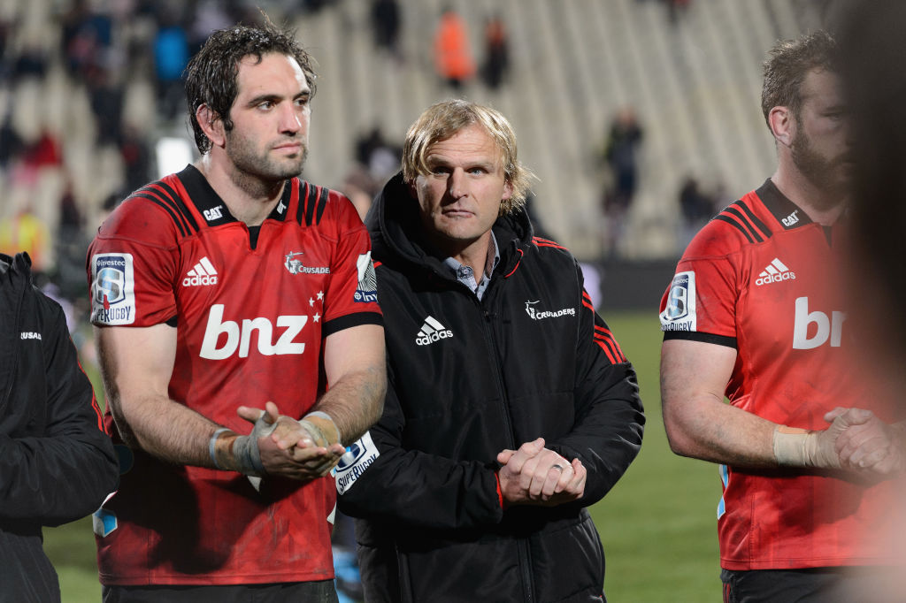 Crusaders coach Scott Robertson (C) and captain Sam Whitelock (L) after their win against the...