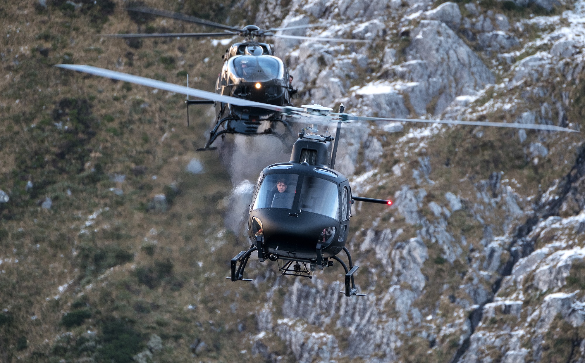 Mission: Impossible — Fallout actors Henry Cavill (back helicopter) and Tom Cruise are filmed in...