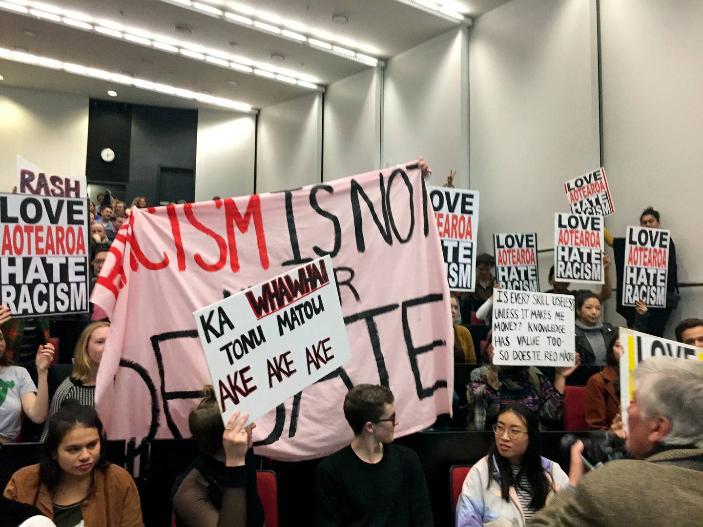 Protesters inside the freedom of speech debate at the University of Auckland where Don Brash...