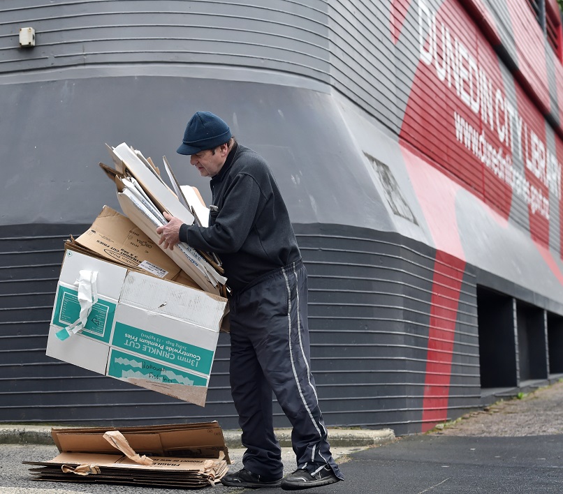 Alister Baird, of Waikouaiti, dumps cardboard in the Dunedin City Council driveway yesterday....