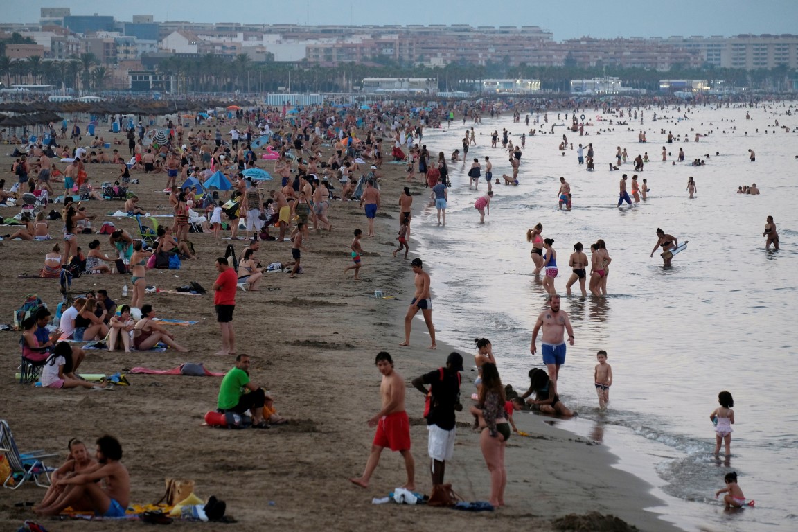 People cool off after sunset on a beach in Valencia, Spain. Photo: Reuters
