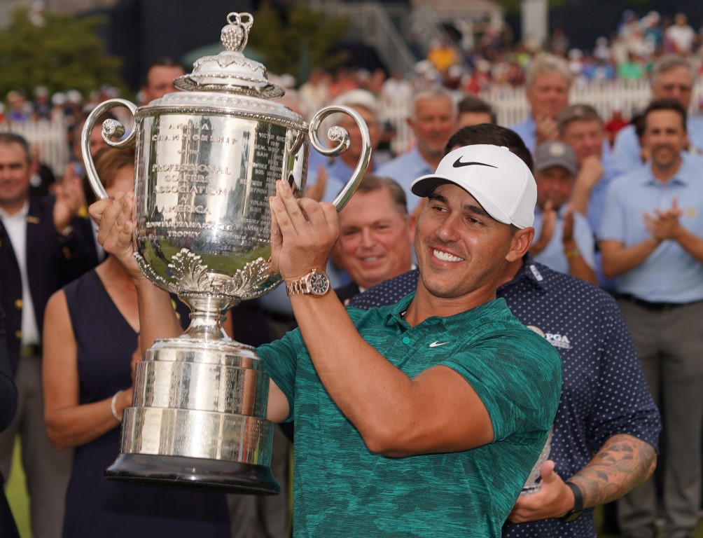 Brooks Koepka hoists the Wanamaker Trophy after winning the PGA Championship at Bellerive Country...