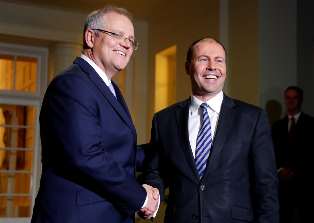 New Australian Prime Minister Scott Morrison (L) shakes hands with the new Treasurer Josh...