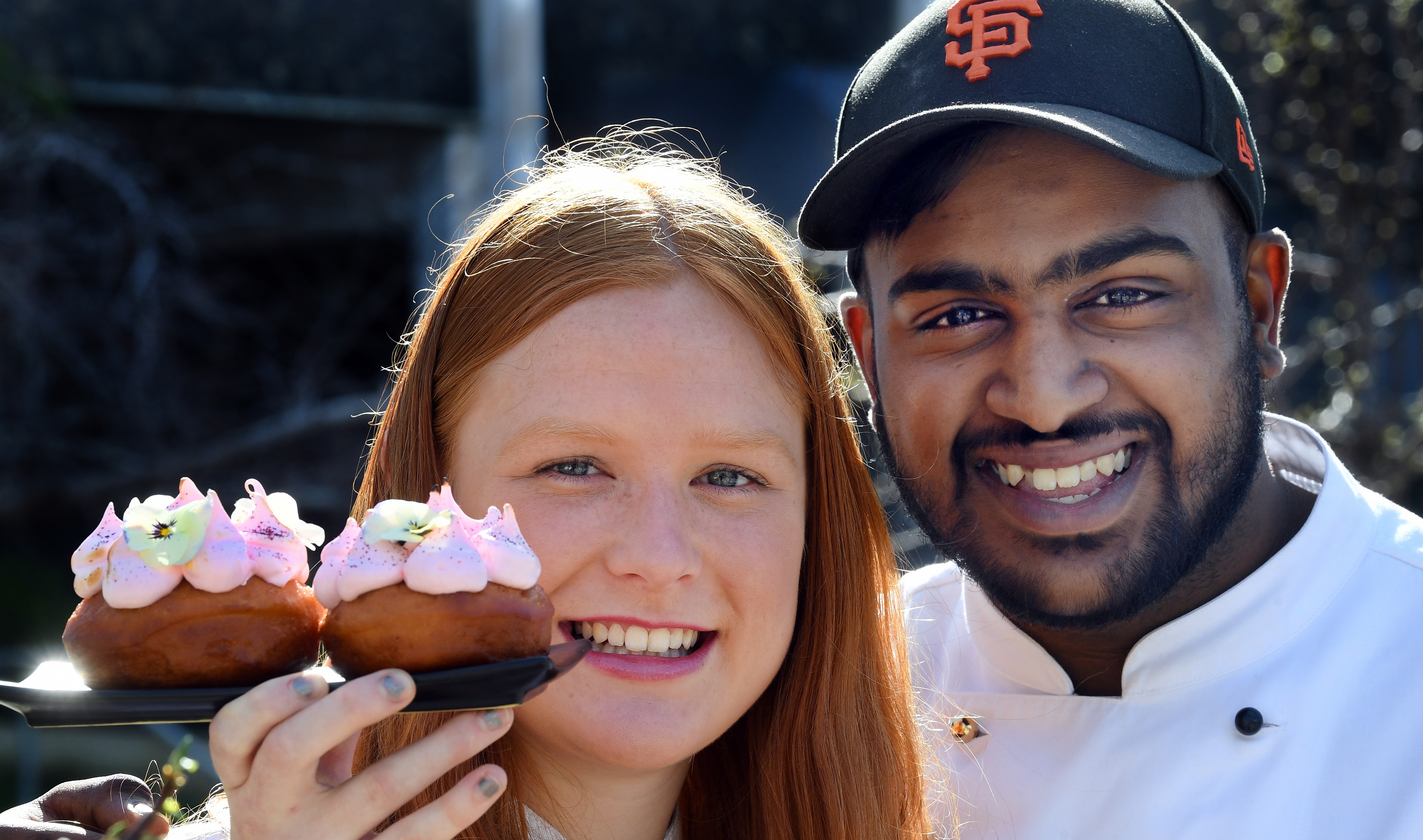 Otago Polytechnic students Georgia Rhodes and Sachien Budhia are making Pink-themed doughnuts...