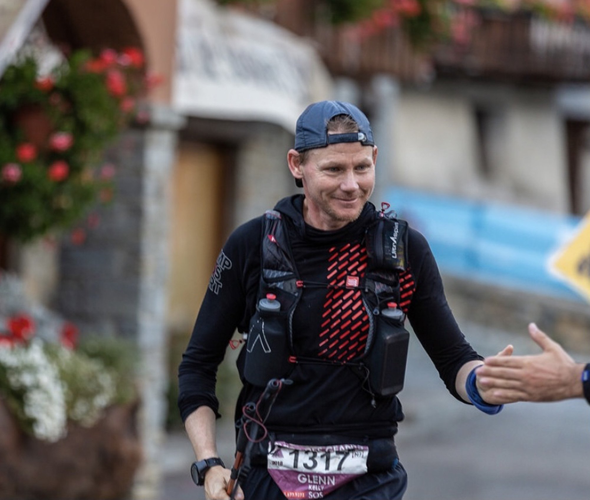 Glenn Kelly celebrates with a spectator during the Tor des Geants ultra running event, which he...