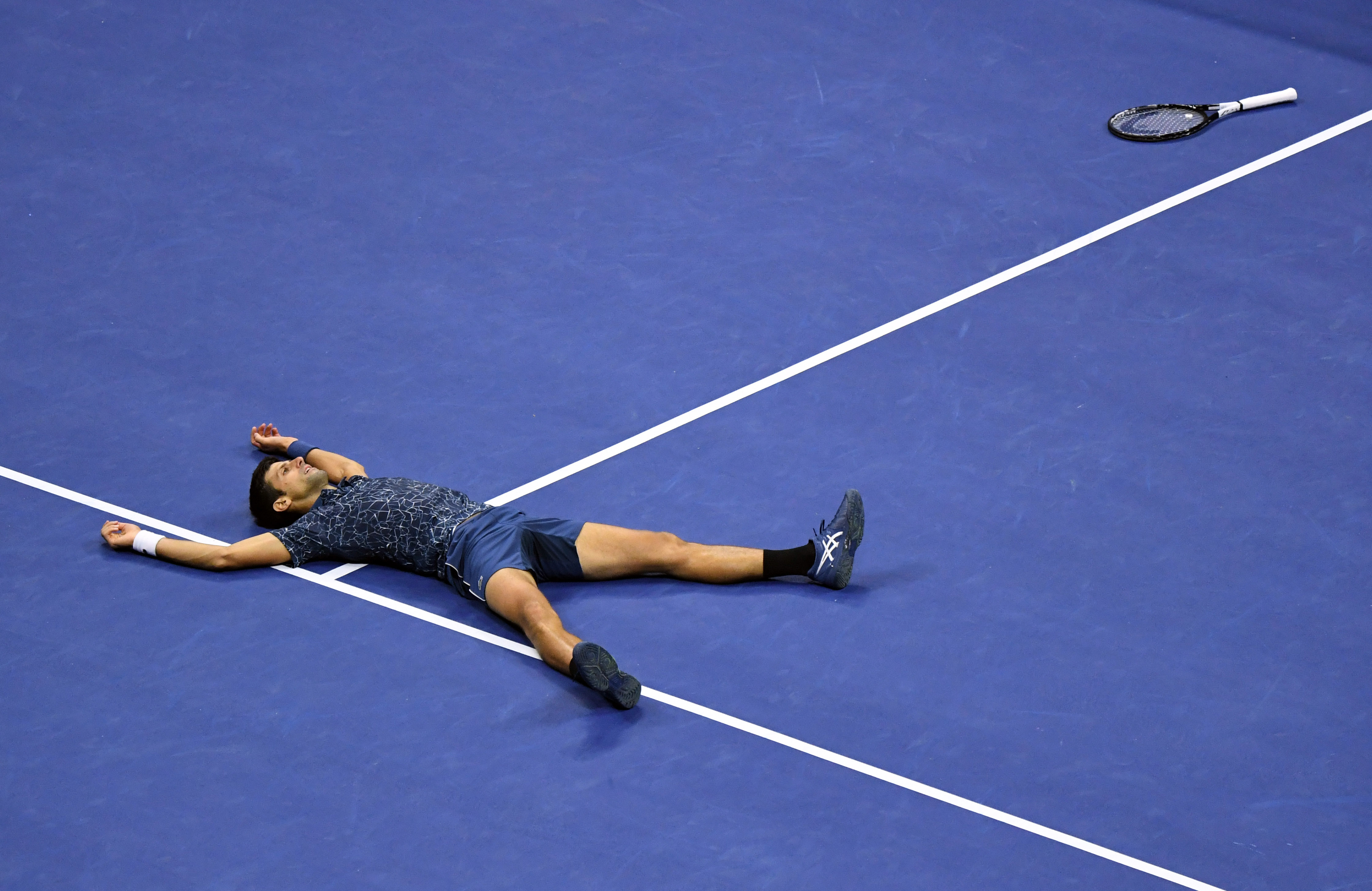 Novak Djokovic of Serbia celebrates match point against Juan Martin Del Potro of Argentina in the...