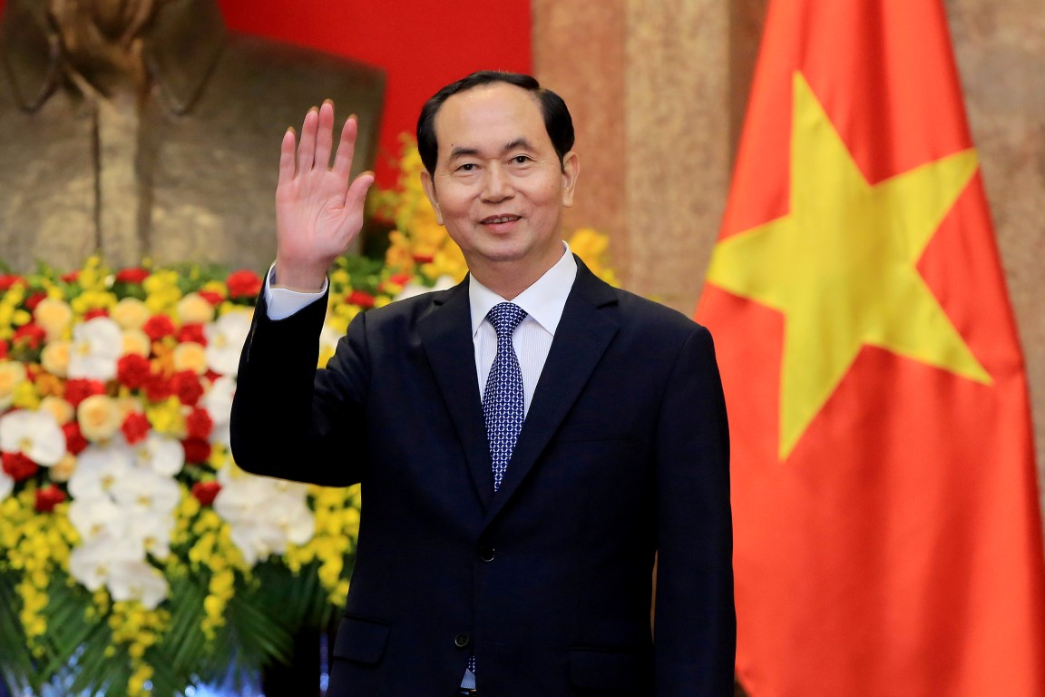 Vietnamese President Tran Dai Quang greets journalists as he waits for the arrival of Russian...