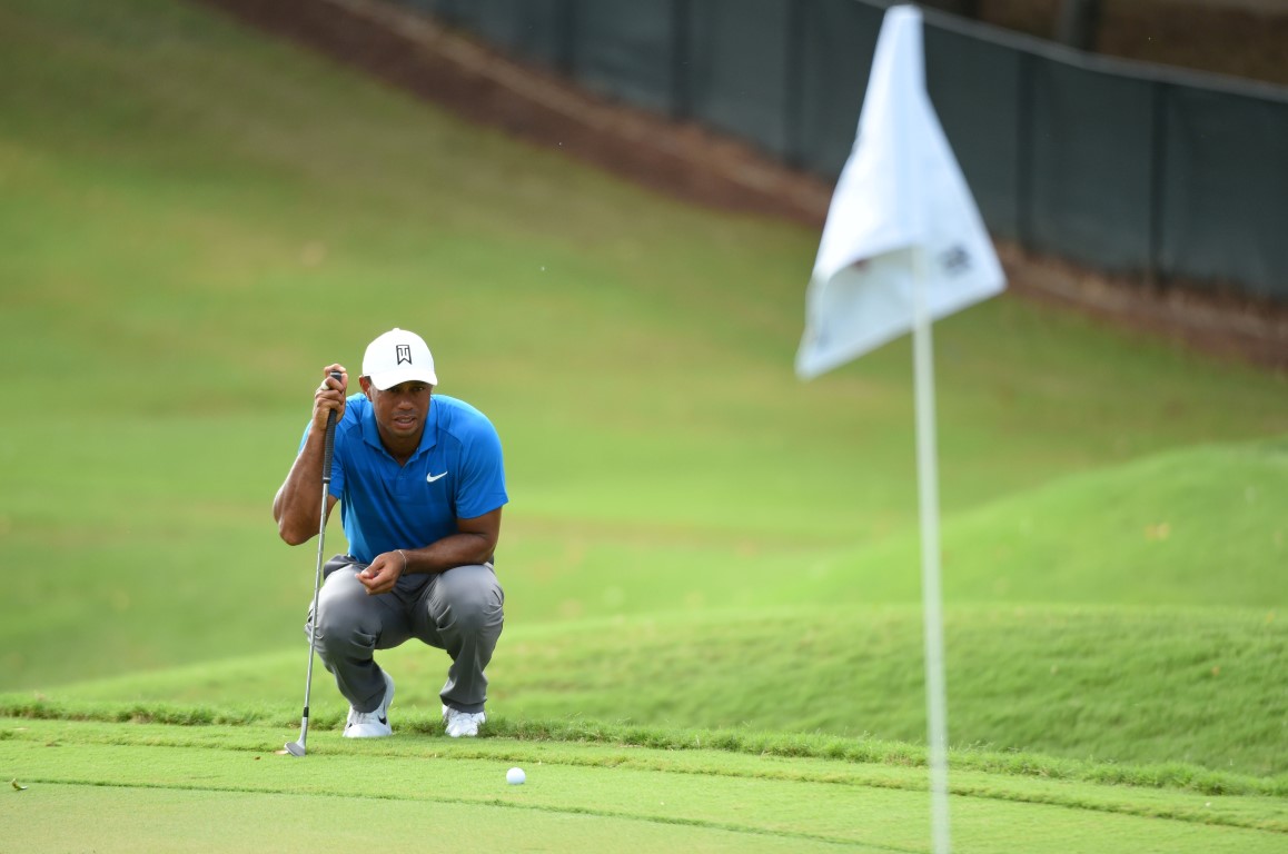 Tiger Woods lines up a shot on the 11th green during the third round of the Tour Championship....