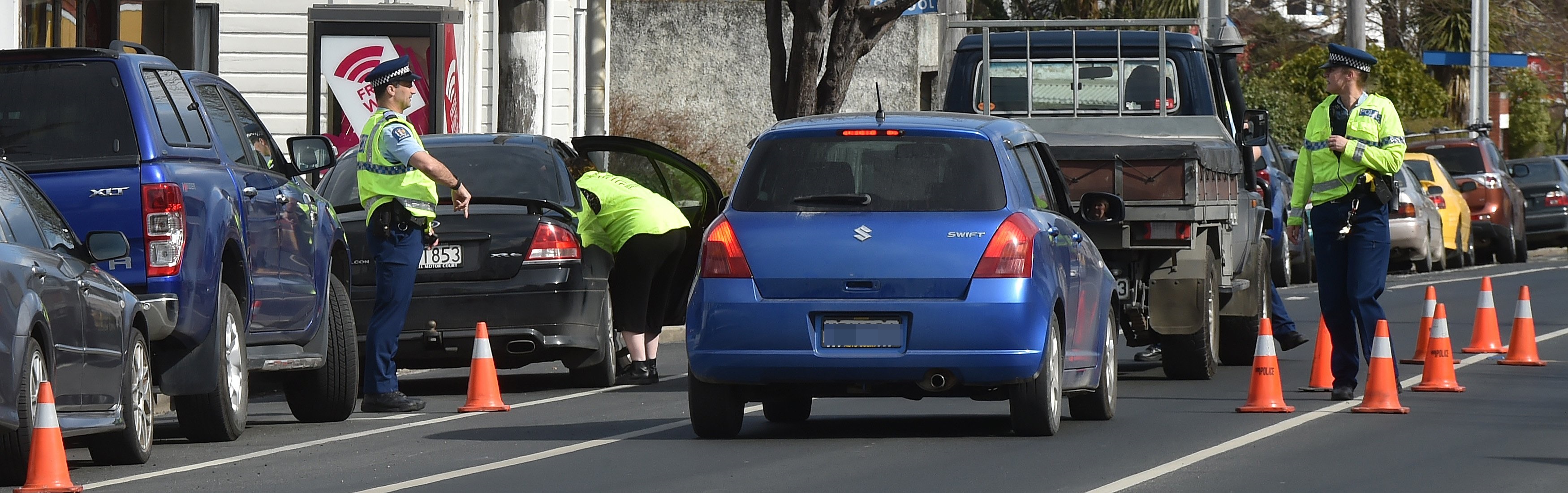 Police check car seats in North Dunedin this week. Photo: Gregor Richardson