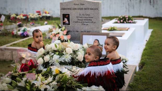 Triplets Blaise (left), Carson and Aayden (far right) Magaoa at the grave of their mother,...